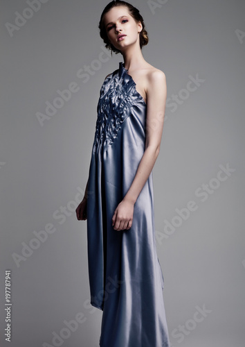 Beautiful fashion model wearing blue silk dress