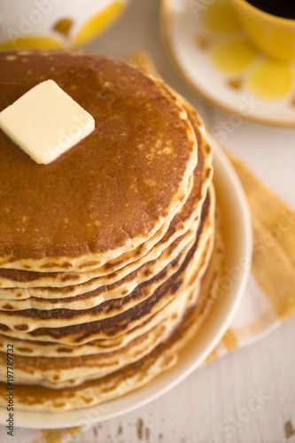 A Stack of Fresh Buttermilk Pancakes with Butter and Syrup