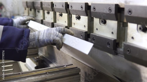Operator working cut and bending metal sheet by high precision metal sheet bending machine, cnc control metal sheet bending machine in factory