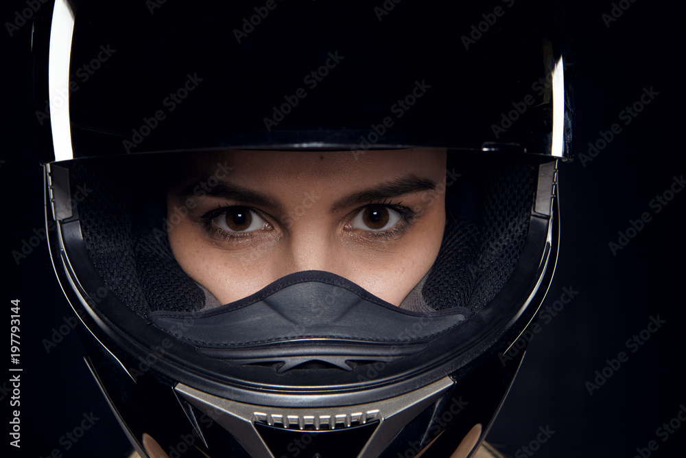 Isolated shot of attractive young brown eyed Caucasian female rider posing  in studio wearing safety motorcycle helmet, staring at camera with  confident look, ready for contest or competition Stock-foto | Adobe Stock