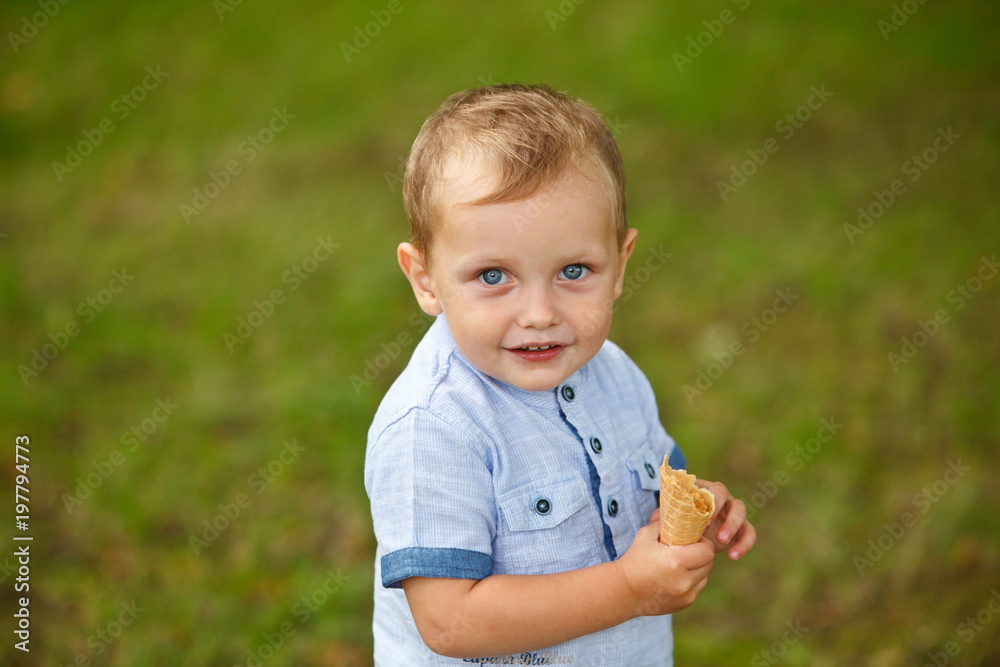 Child with ice cream cone. Little boy eats ice-cream in park. Child with ice cream cone. Little boy eats ice-cream in park.