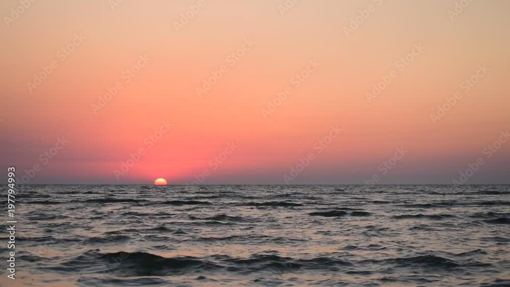 Beautiful landscape during sunrise above sea with clear sky with waves on water Beautiful landscape during sunrise above sea with clear sky with waves on water