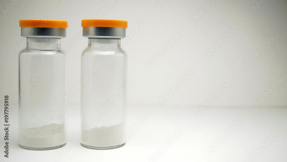 a person takes an ampoule with white powder a person takes an ampoule with white powder