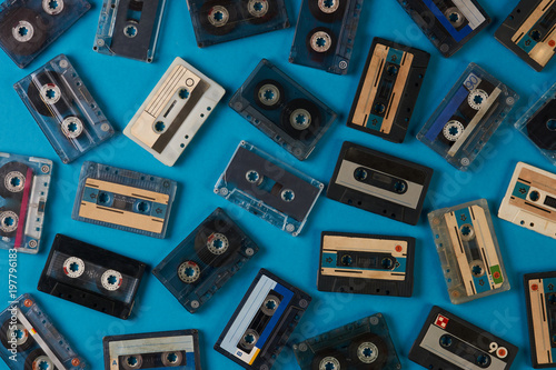 Set of old retro audio cassettes tape on blue background, close-up top view. 