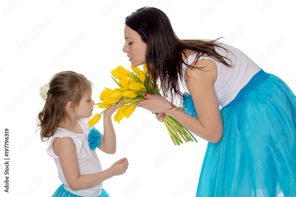 Mom and daughter enjoying the fragrance of flowers. Mom and daughter enjoying the fragrance of flowers.