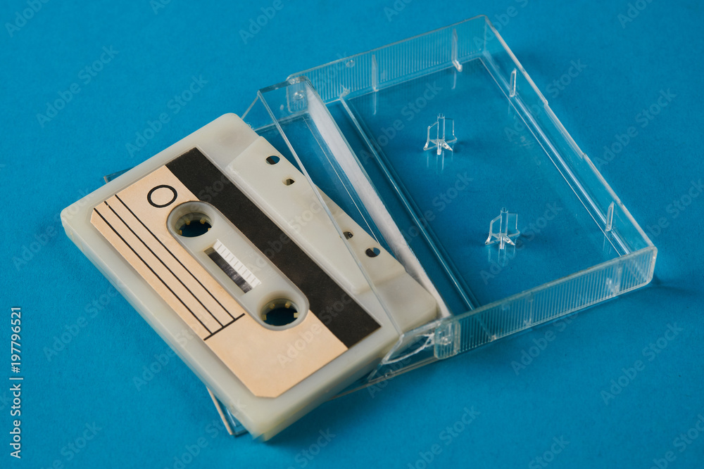 Blank cassette tape box on blue background. Vintage cassette tape case
