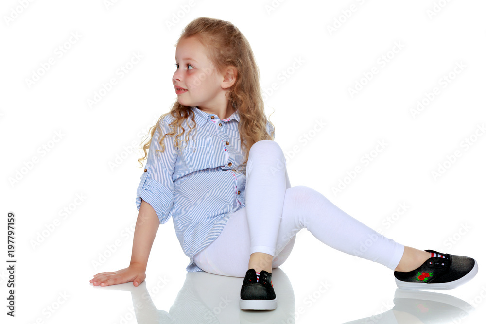 Little girl is sitting on the floor. Little girl is sitting on the floor.