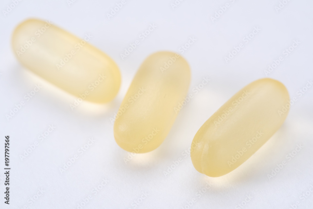 yellow white pills capsule isolated on white background