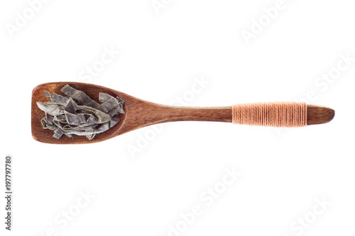 spice dried seaweed in  wooden spoon isolated on a white background, top view