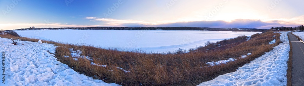 Scenic Wide Panoramic Landscape View of Snowy Frozen Glenmore Reservoir, Elbow River and Rocky Mountains Foothills in Southwest Calgary Alberta Canada