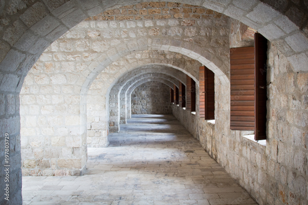 Series of Leading Stone Archways Leading with Spaced Windows in a Cloisters