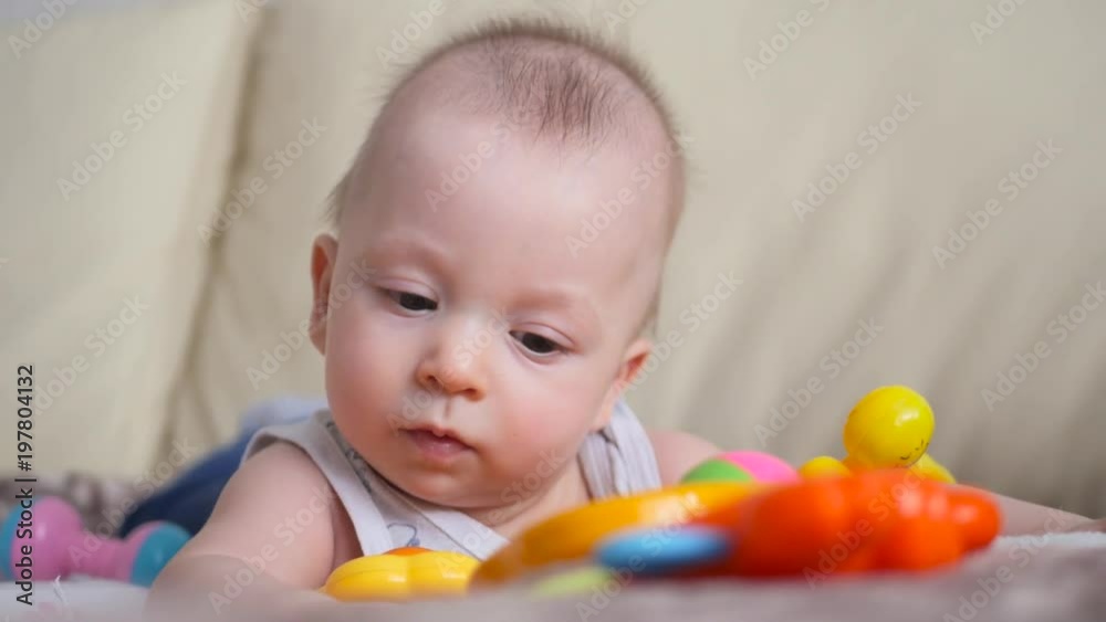 Funny little child playing with toys by the home Funny little child playing with toys by the home