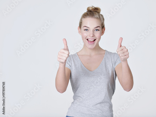 Fun portrait of a woman giving a thumbs up