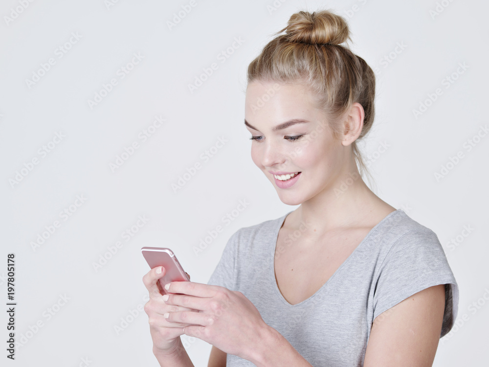 woman is typing text message on mobile phone woman is typing text message on mobile phone