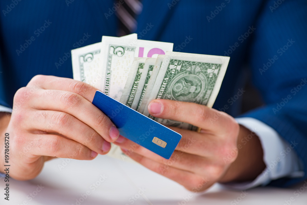 Businessman holding dollar money and credit card Businessman holding dollar money and credit card