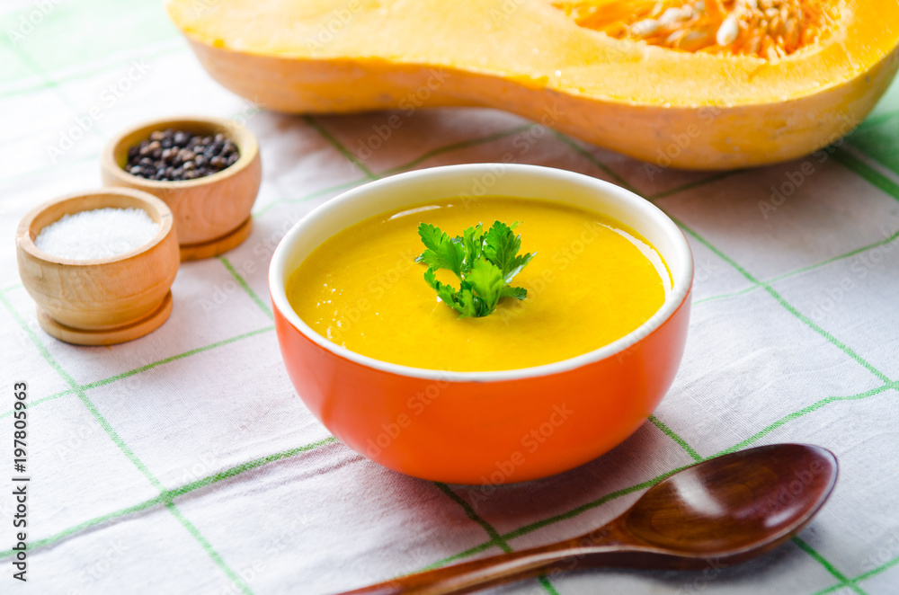 Pumpkin soup served on the table in bowl Pumpkin soup served on the table in bowl