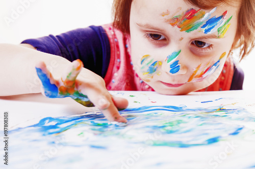 Child girl painting with colorful hands. ( art, childhood, drawing concept)