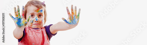 Humorous image of cute little child girl with colorful painted hands.