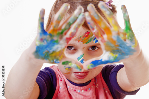 Colorful painted hands in a cute child girl (art, childhood, color)