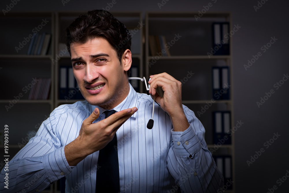 Naklejka premium Tired and exhausted helpdesk operator during night shift