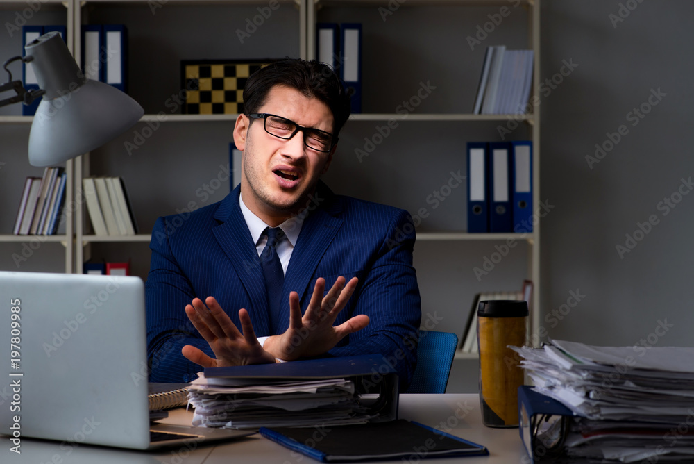Employee working late to finish important deliverable task Employee working late to finish important deliverable task