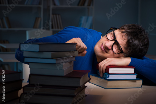 Student preparing for exams late at night in library