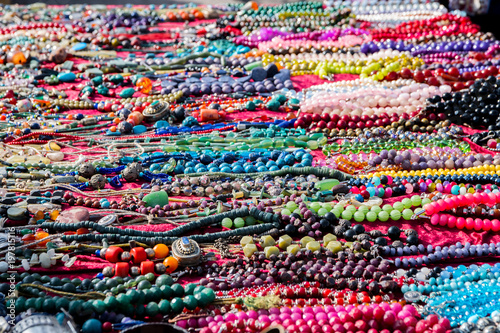 Colorful necklaces for sale at the flea market, consumption background, selected focus, narrow depth of field