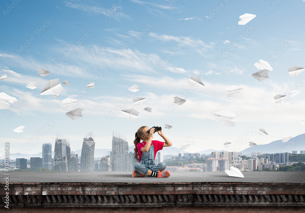 Concept of careless happy childhood with girl of school age looking in future Concept of careless happy childhood with girl of school age looking in future