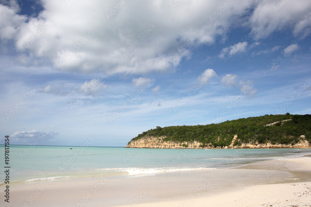 Beautiful landscape of Runaway Beach in Antigua, with golden sand, turquiose sea & blue sky, Caribbean.