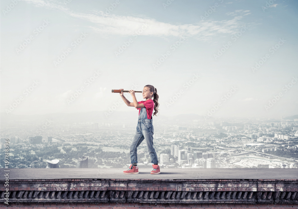 Concept of careless happy childhood with girl exploring this wor Concept of careless happy childhood with girl exploring this wor