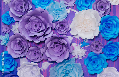 blue  purple and white paper flowers on a lilac wall. Photo Area