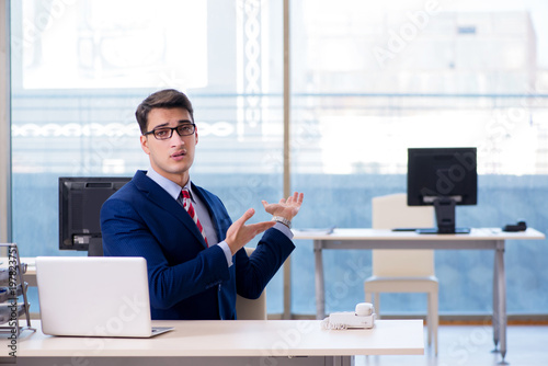 Businessman employee unhappy about absent employee photo