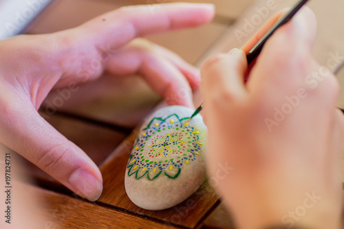 Girl colouring pebbles