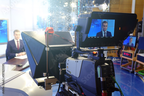 The news presenter reads the text on the teleprompter.Camera in the office. TV studio. photo