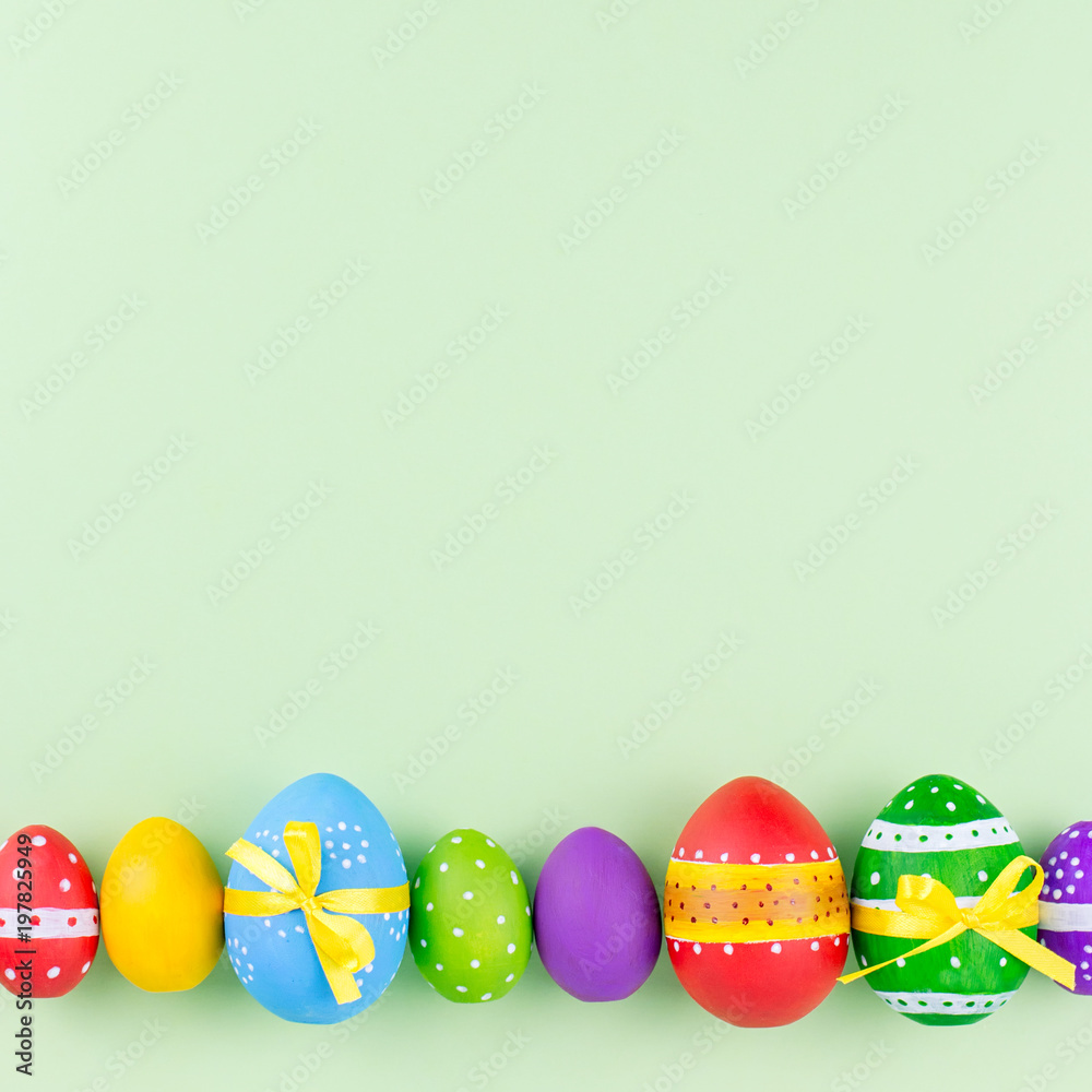 Colorful easter eggs on pastel green background flat lay. Copy space Colorful easter eggs on pastel green background flat lay. Copy space