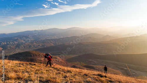 Travelers climbs to the mountain peak