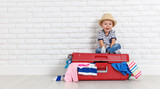 concept travel. happy funny boy child with suitcase