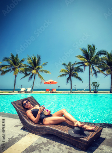 Woman at the swimming pool at the tropical resort