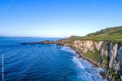 Northern Ireland, UK. Atlantic coast with cliffs and far aerial view of Carrick-a-Rede National Trust in County Antrim © kilhan