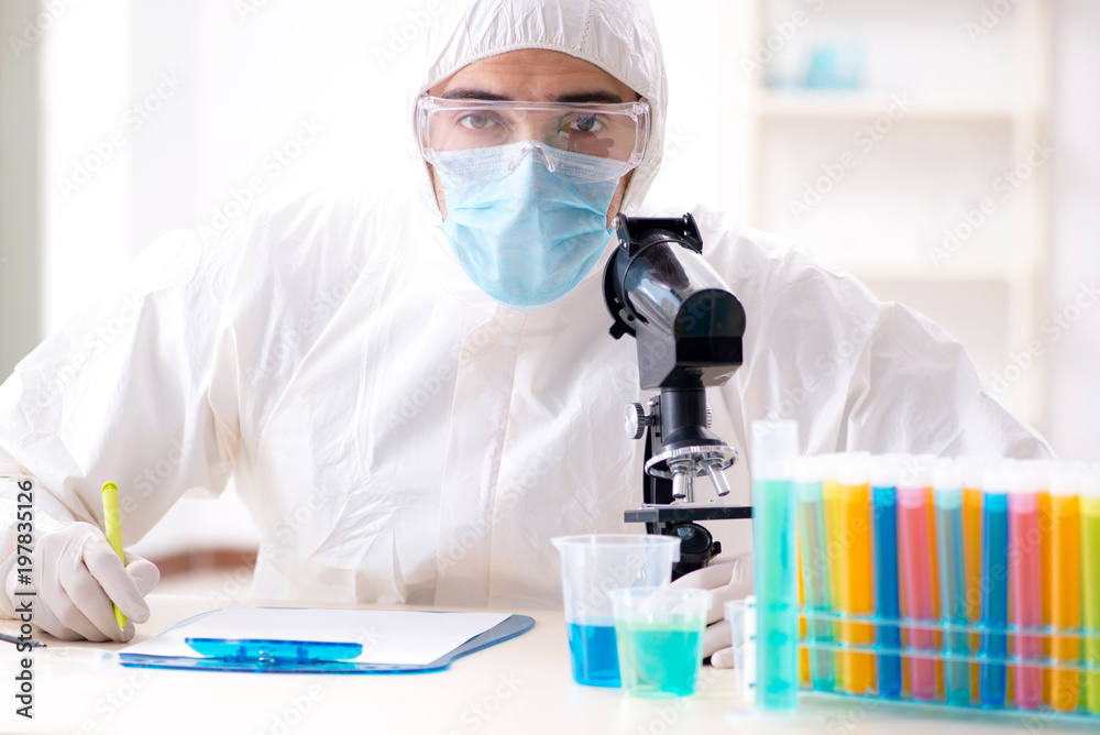 Young chemist student working in lab on chemicals Young chemist student working in lab on chemicals