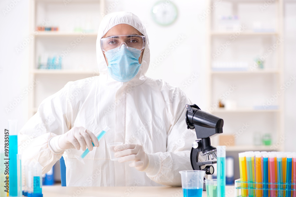 Young chemist student working in lab on chemicals Young chemist student working in lab on chemicals