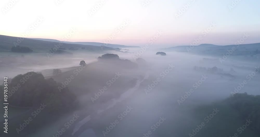 Aerial shot of flying over foggy valley before sunrise. Aerial shot of flying over foggy valley before sunrise.