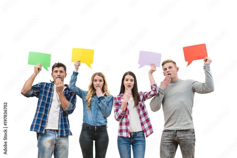 Obraz premium The four surprised people hold dialog signs on the white background