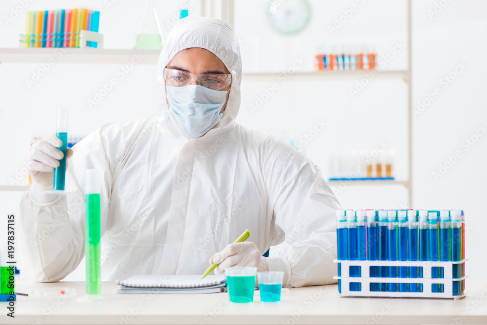 Young chemist student working in lab on chemicals Young chemist student working in lab on chemicals