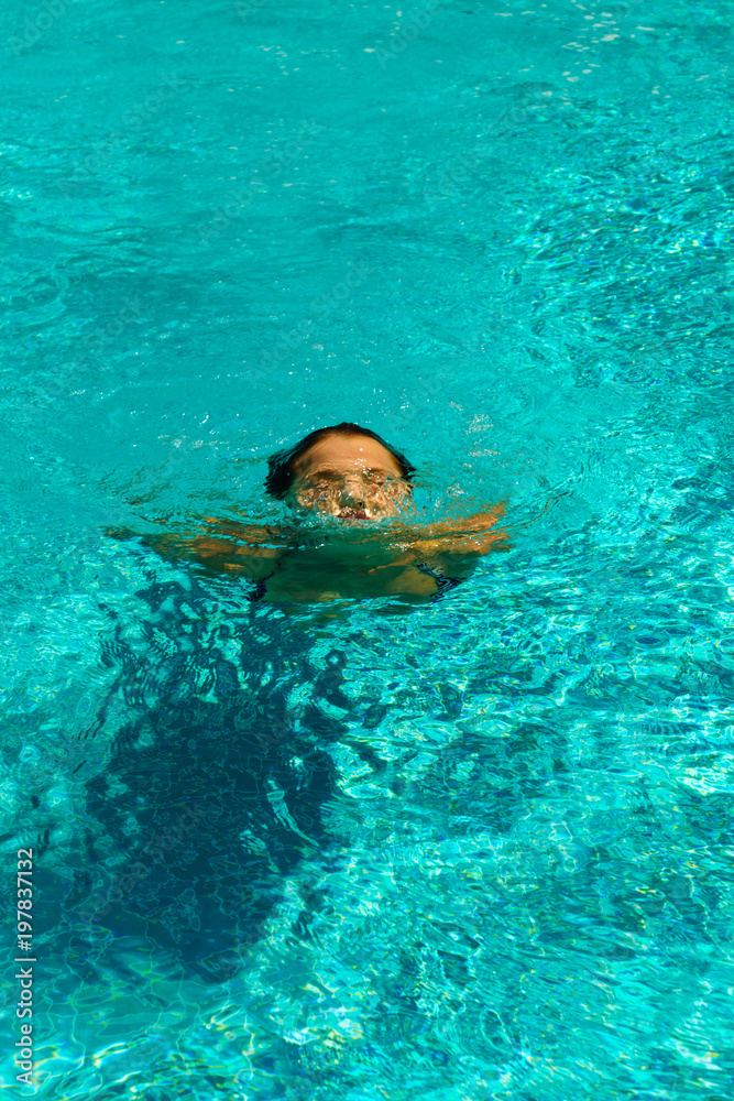 Beautiful tanned woman in swimwear relaxing in swimming pool Stock ...
