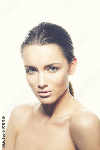 Beauty portrait of caucasian model girl with blue eyes, brunette hair, clean skin, naked shoulders, clean skin. Skincare facial treatment concept