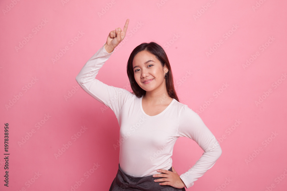 Young Asian woman smile and point up. Young Asian woman smile and point up.