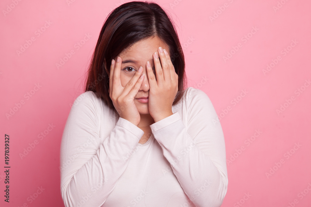 Beautiful young Asian woman peeking through fingers. Beautiful young Asian woman peeking through fingers.