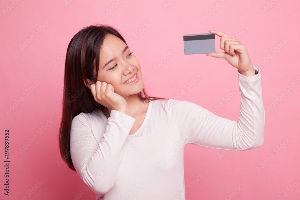 Happy young Asian woman with a blank card.