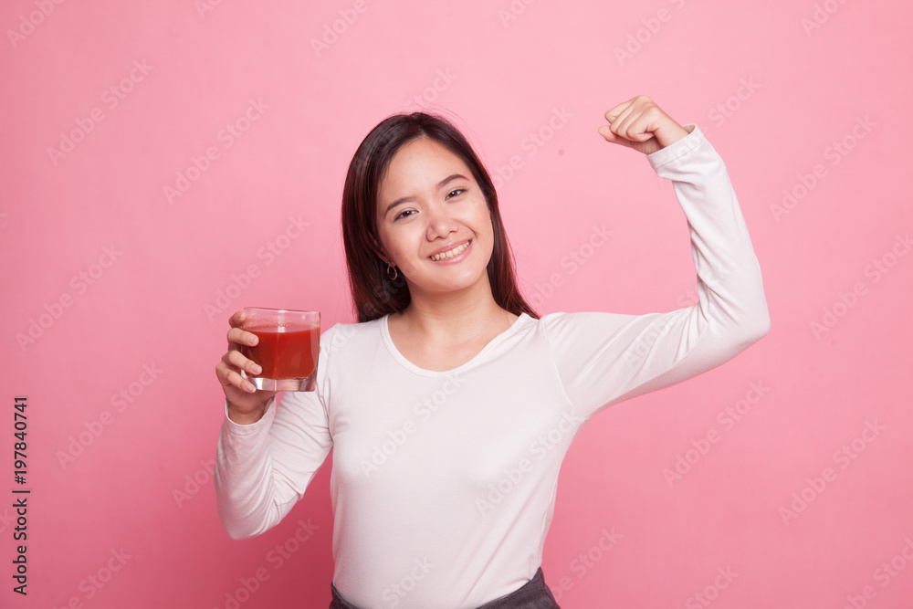 Strong healthy Asian woman with tomato juice.